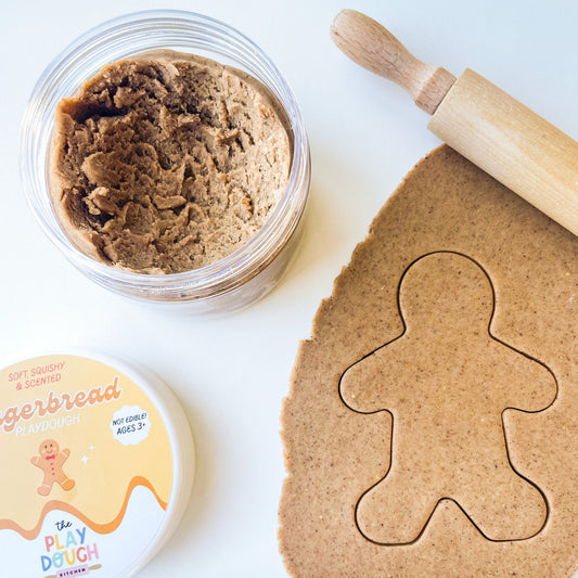 Light brown gingerbread playdough rolled out onto a surface