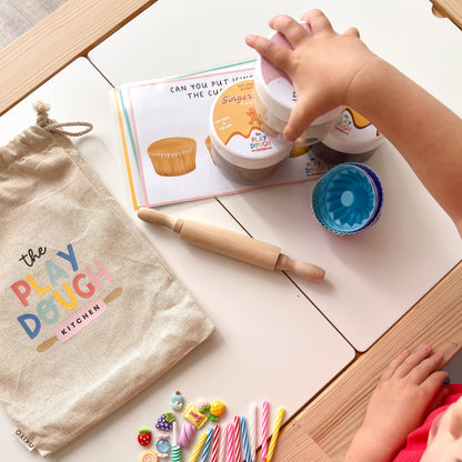 Children's baking themed play dough kit with tools on a table