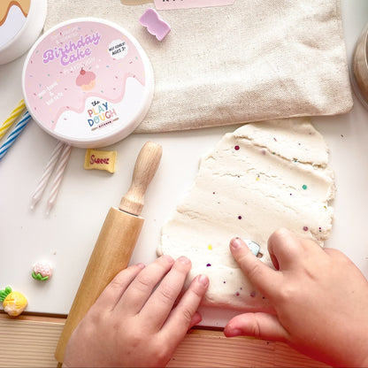 Birthday cake playdough with colourful glitter rolled out with a rolling pin