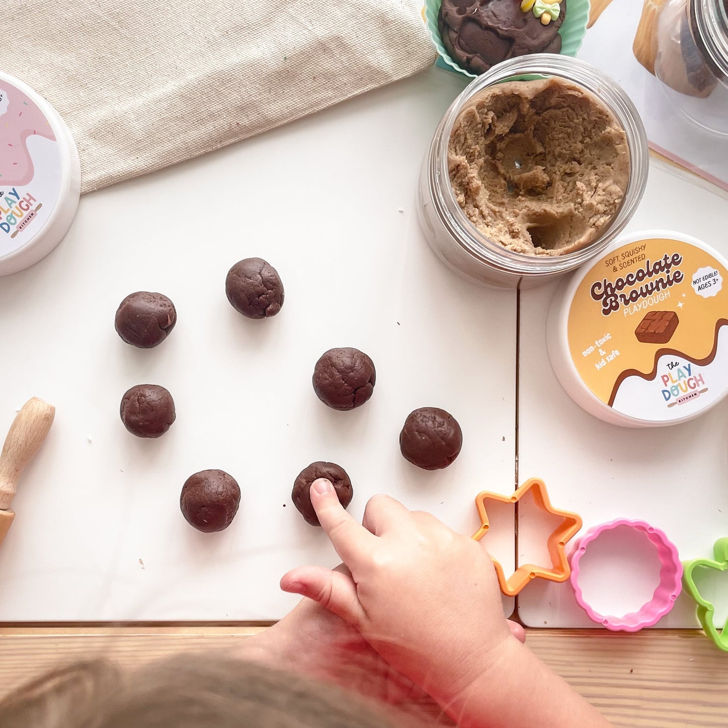 Chocolate playdough rolled into balls on a table