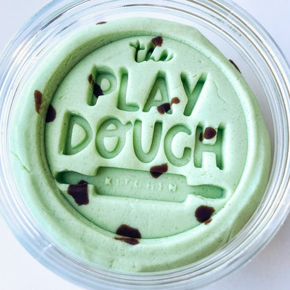Jar of green play dough with 'The Play Dough Company' branding on a white background